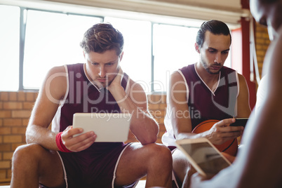 Basketball players using digital tablet