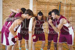 Basketball players forming a huddle