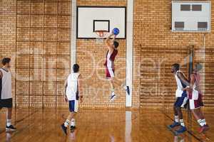 Basketball players playing in the court