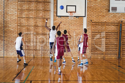 Basketball players playing in the court