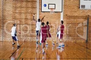 Basketball players playing in the court