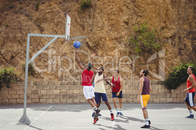 Basketball players playing basketball in the court