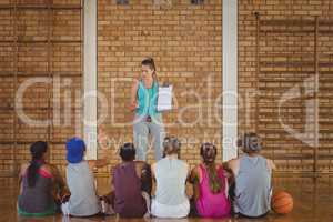 Female coach mentoring high school kids