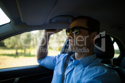 Man wearing sunglasses in car