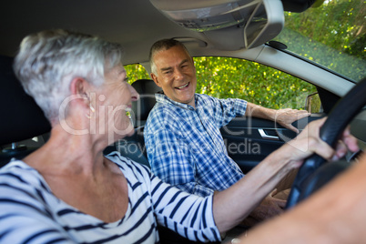 Senior couple sitting in car