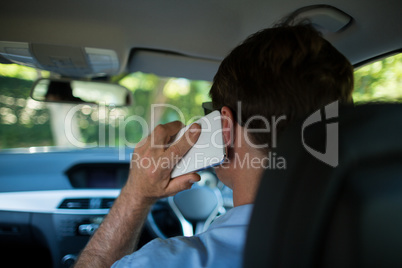 Man talking on phone while driving car
