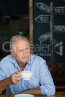 Close up of senior man holding coffee cup