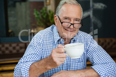 Portrait of happy senior man at cafe