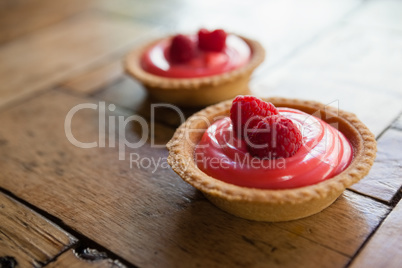 Close up of raspberry tart on wooden table