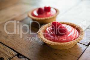 Close up of raspberry tart on wooden table