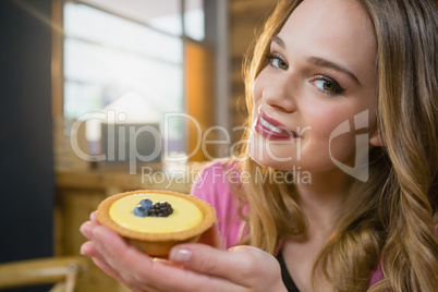 Portrait of beautiful woman holding cupcake