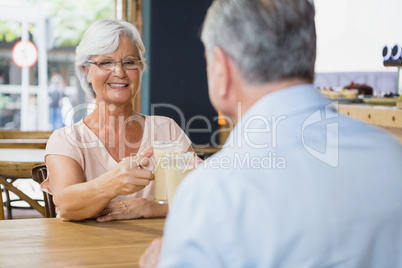 Senior couple toasting glasses of cold coffee