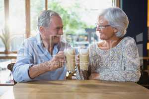 Senior couple toasting glasses of cold coffee