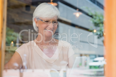 Happy senior woman using mobile phone