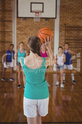 High school kids playing basketball in the court