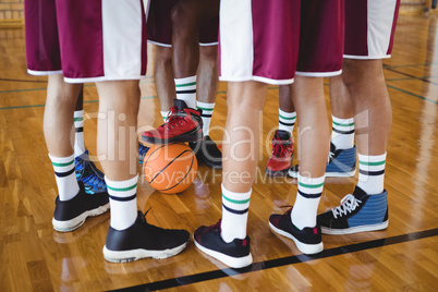 Basketball players forming a huddle