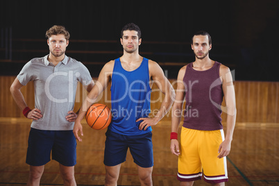 Male basketball players standing in basketball court