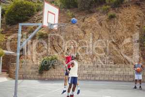 Basketball players playing in basketball court