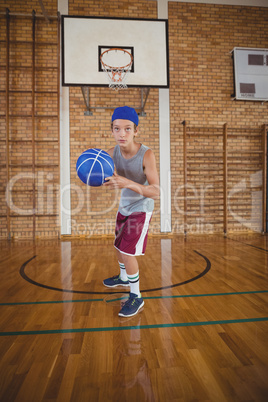 High school boy playing basketball in the court