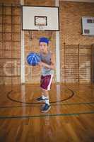 High school boy playing basketball in the court