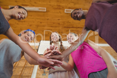 High school kids with their hands stacked