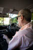 Senior man driving car