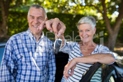Senior couple showing car keys
