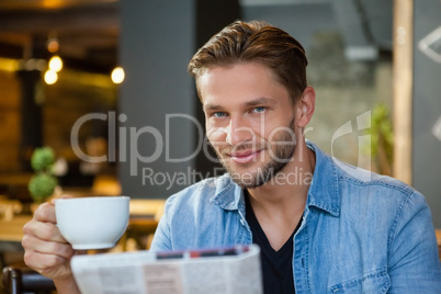 Portrait of handsome man holding coffee cup