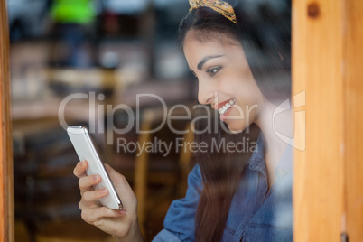 Smiling woman using mobile phone