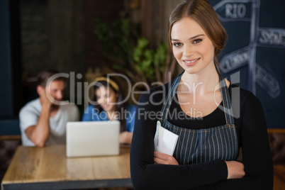 Portrait of smiling owner standing against customer