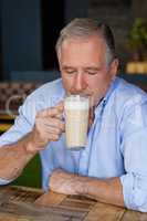 Senior man drinking cold coffee