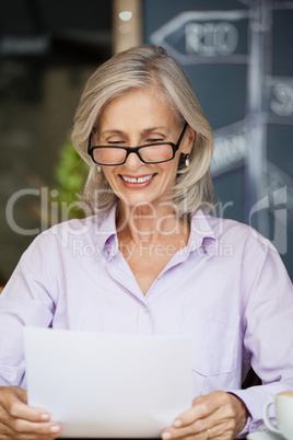 Happy senior woman holding tablet computer