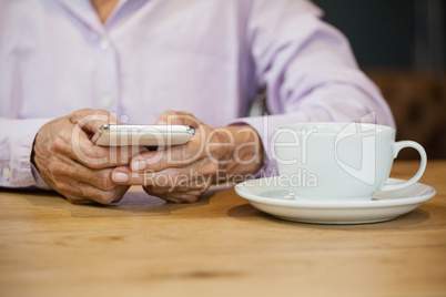 Midsection of senior woman using smart phone