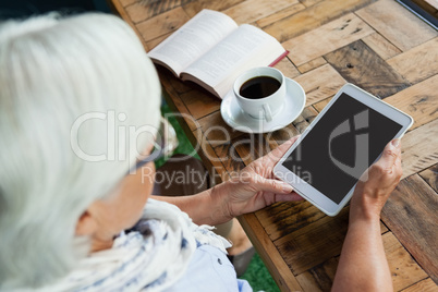 Close up of woman using tablet on table