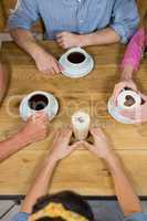 Friends having coffee at table