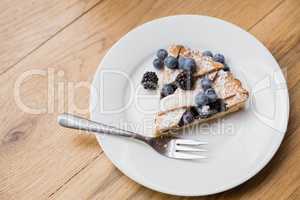 Tart with blackberries and blueberries on a plate