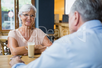 Senior couple interacting while having coffee