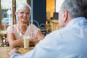 Senior couple interacting while having coffee