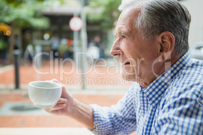 Senior man holding a coffee cup