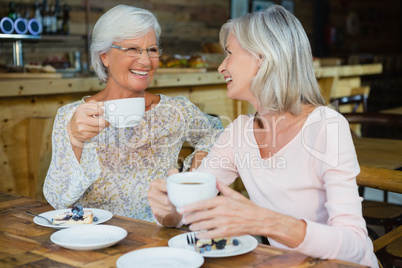 Happy senior friends having coffee and breakfast