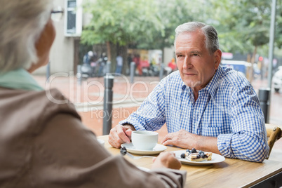 Senior couple sitting with coffee