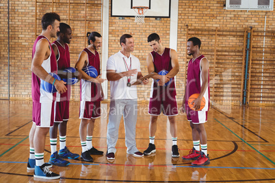 Coach interacting with basketball players