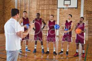 Basketball coach interacting with players