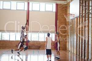 Basketball players playing in the court