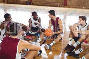 Basketball players interacting while relaxing