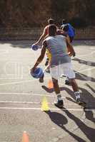 Basketball players practicing dribbling drill