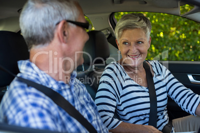 Senior couple looking at each other in car