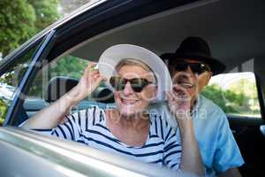 Senior couple looking through car window