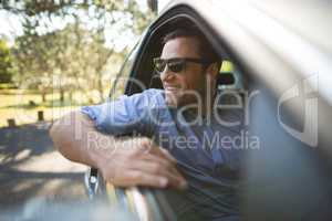 Young man sitting in car