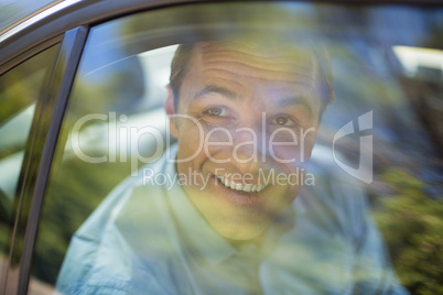 Man looking through car window